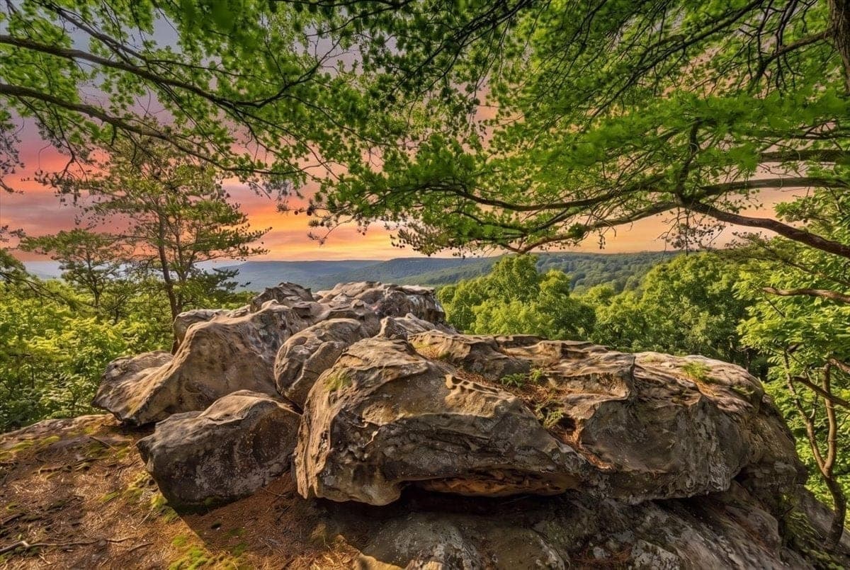 Ground-level view from High Rock, the sandstone formation on Lot 55 at sunset, overlooking the valley and distant ridges.